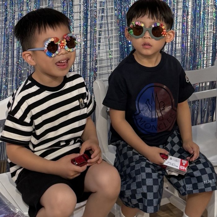Two boys wearing their decorated DIY party sunglasses